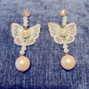Dangling butterfly earrings.